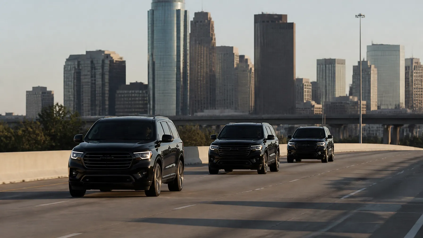 Black executive vehicles moving together through Houston
