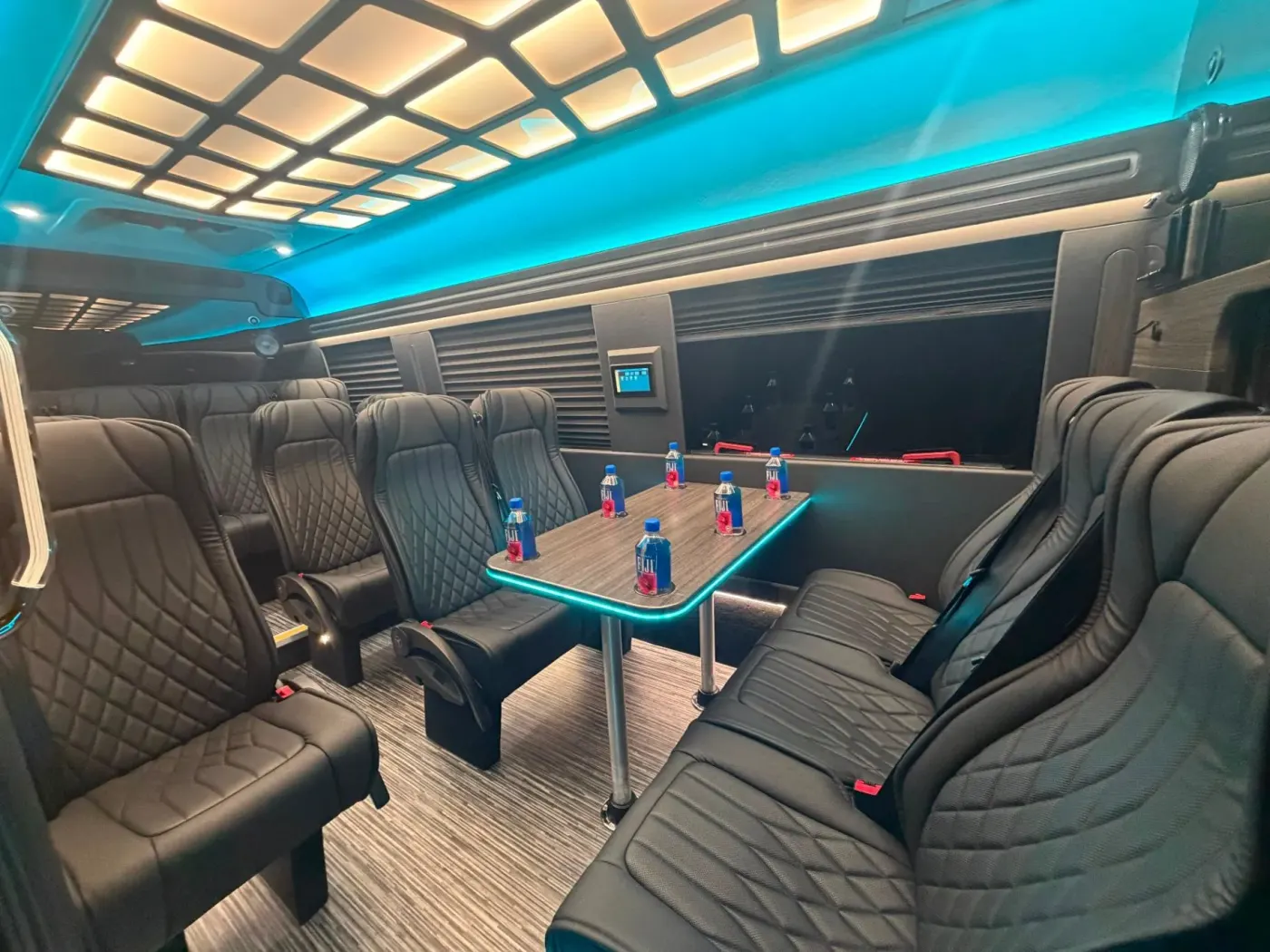 Executive Sprinter rear cabin with passenger seating and a table