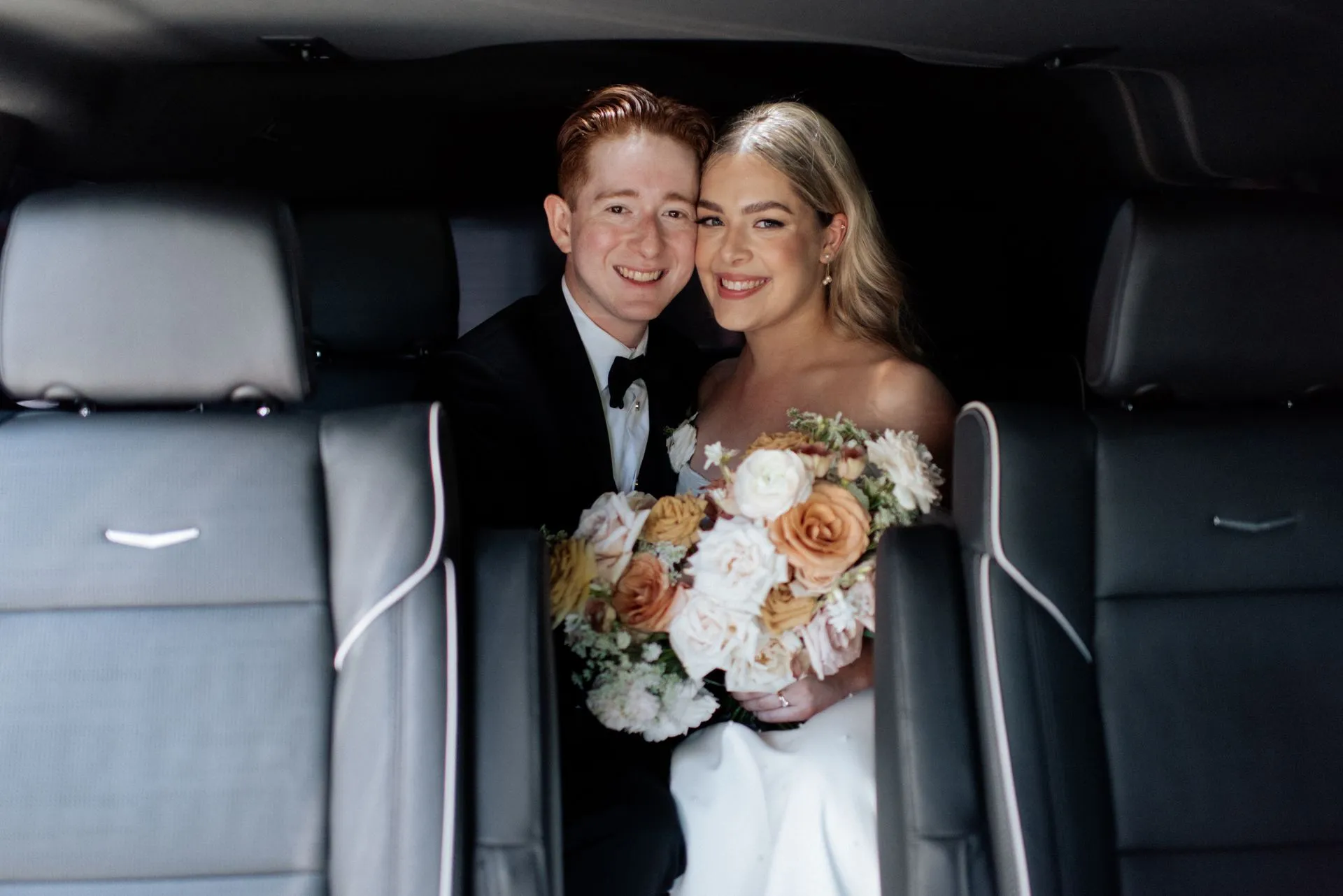 Couple enjoying a luxury vehicle arrival for a celebration